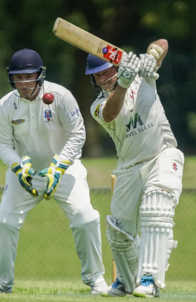 Simon Dart hits through cover in an MPCA match against Long Island. Picture: Valeriu Campan