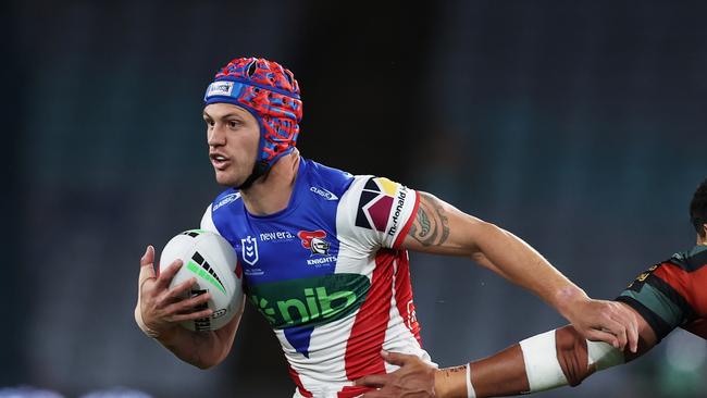 SYDNEY, AUSTRALIA - AUGUST 24:  Kalyn Ponga of the Knights takes on the defence during the round 25 NRL match between South Sydney Rabbitohs and Newcastle Knights at Accor Stadium, on August 24, 2024, in Sydney, Australia. (Photo by Matt King/Getty Images)