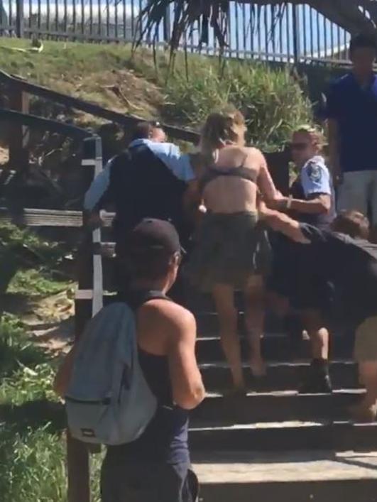 The controversial arrest of a woman on a Byron Bay beach.