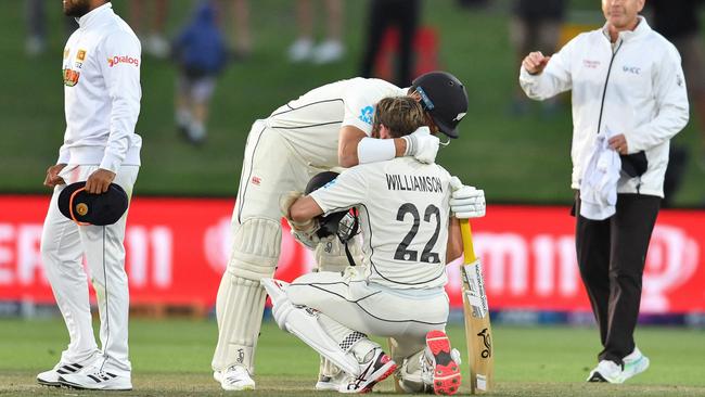 New Zealand's Neil Wagner (2L) hugs his teammate Kane Williamson after winning the first Test cricket match against Sri Lanka at Hagley Oval in Christchurch on March 13, 2023. (Photo by Sanka Vidanagama / AFP)