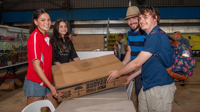James and Angus gets their fireworks from Brianna Balfour and Hollie Hay at the Fireworks Warehouse at Darwin show grounds sale on Territory Day. Picture: Pema Tamang Pakhrin