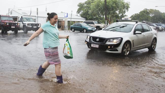 Cloncurry resident Jamie-Lea McConachey braves the wet weather to stock up on supplies yesterday. Picture: Lachie Millard