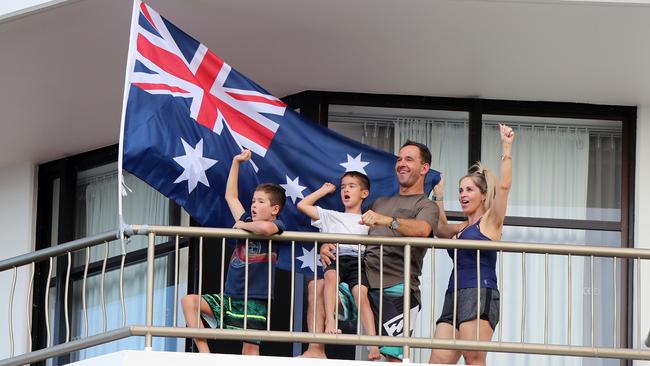 Lenny and Suzanne Patterson with their boys Levi, 10, and Cooper, 7, watch the beach volleyball from their balcony. Picture: Alex Coppel