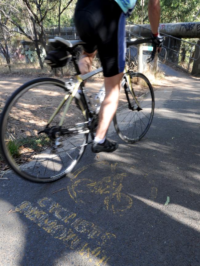 The faded “Cyclists Dismount” sign on the approach to the pedestrian-only bridge near Fairfield Boathouse. Picture: Andrew Henshaw