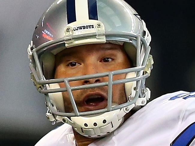 ARLINGTON, TX - OCTOBER 19: Tony Romo #9 of the Dallas Cowboys signals to a reciever as Mike Patterson #93 of the New York Giants applies pressure in the second half at AT&T Stadium on October 19, 2014 in Arlington, Texas. Ronald Martinez/Getty Images/AFP == FOR NEWSPAPERS, INTERNET, TELCOS & TELEVISION USE ONLY ==