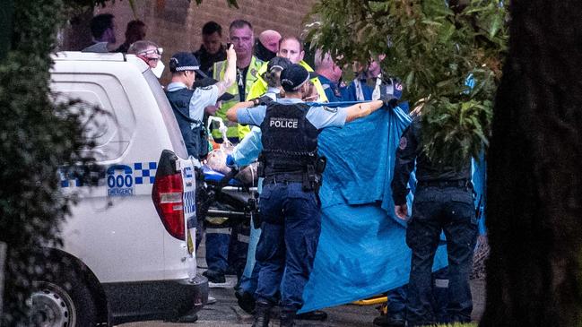 Police and medical staff at the scene as the second man is moved into an ambulance. Picture: Flavio Brancaleone