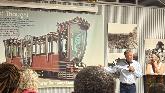 Greg Rogerson speaking to the public in front of the Tram design.