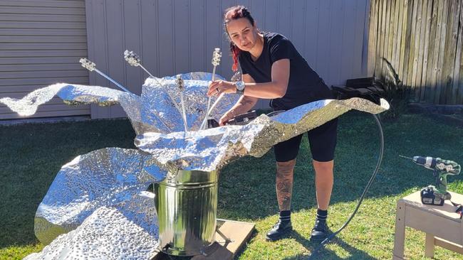 Shotgun artist, Rae Saheli, 51, of Palm Beach, working on one of her newest sculptures that will feature in the annual Swell Sculpture Festival on Currumbin Beach on the Gold Coast from September September 6-15. Picture: Supplied