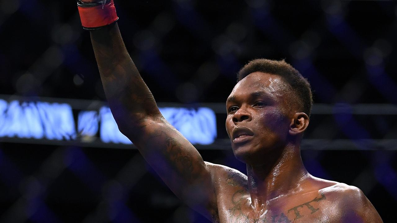 Israel Adesanya celebrates a decision win over Yoel Romero.