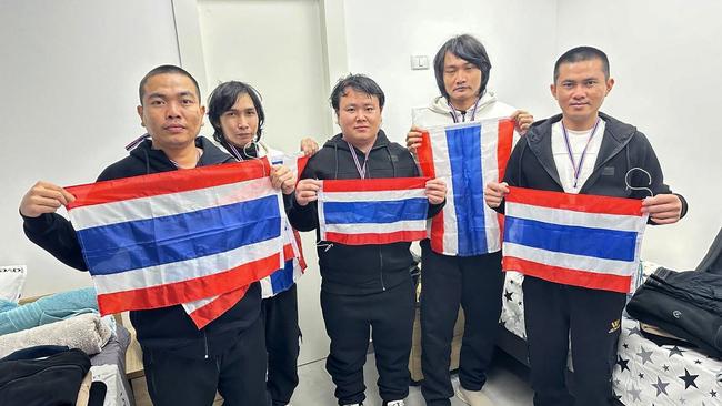 Released Thai hostages Surasak Rumnao, left, Sathian Suwannakham, Bannawat Saethao, Watchara Sriaoun and Pongsak Thaenna pose with Thai national flags in Tel Aviv. Picture: AFP