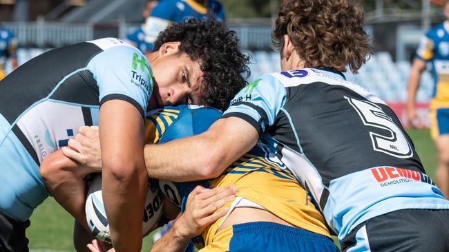 Cronulla players lock an opponent in a tackle. Picture: Monique Harmer