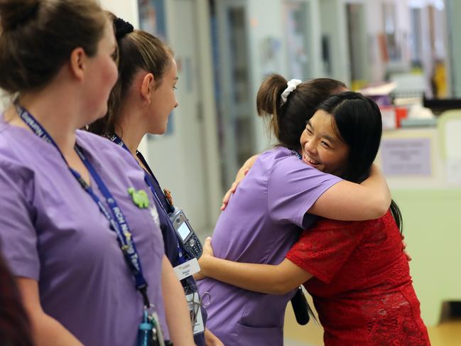 Mum Bhumchu Zangmo hugs ward nurses as she leaves the Royal Children's Hospital with twins Nima and Dawa. Picture: Alex Coppel