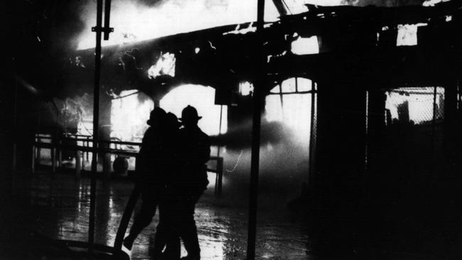 Firemen at scene of Ghost Train ride fire that killed 6 children and 1 adult at Luna Park in Sydney in 1979.