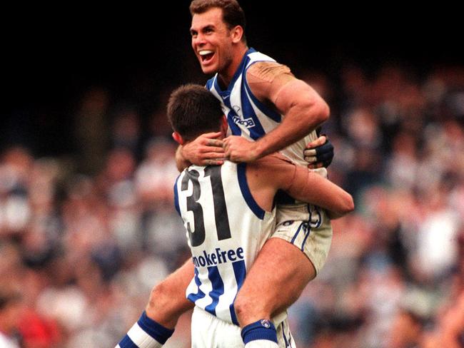 Wayne Carey celebrates with teammate Corey McKernan.