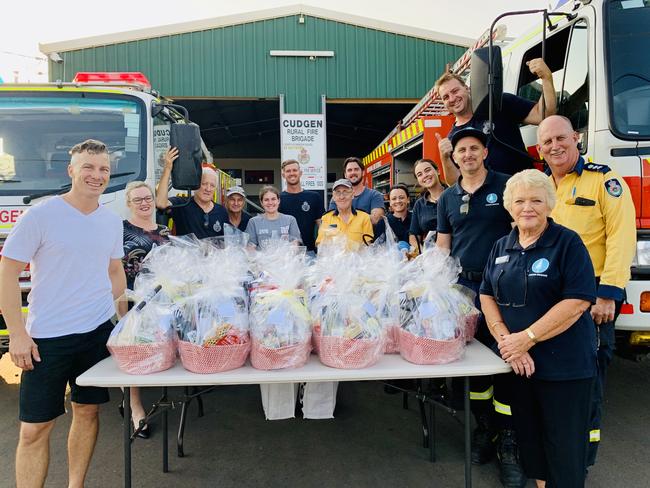 Kingscliff and District Chamber of Commerce president James Owen joins Cudgen Rural Fire Service volunteers at the presentation of hampers to them as a way of saying 'thank you' for their tireless efforts in fighting fires on the Northern Rivers. Photo: SUPPLIED