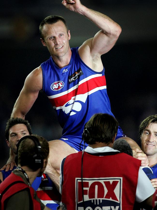 Grant is chaired off after his 300th game for the Bulldogs.