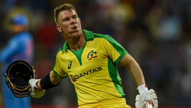 Australia's David Warner celebrates after scoring a century (100 runs) during the first one day international (ODI) cricket match of a three-match series between India and Australia at the Wankhede Stadium in Mumbai on January 14, 2020. (Photo by Punit PARANJPE / AFP) / IMAGE RESTRICTED TO EDITORIAL USE - STRICTLY NO COMMERCIAL USE