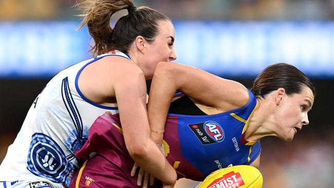 Sophie Conway of the Lions attempts to break away from the defence of Nicole Bresnehan of the Kangaroos during the round eight AFLW match between the Brisbane Lions and the North Melbourne Kangaroos at The Gabba on March 20, 2021 in Brisbane, Australia. (Photo by Bradley Kanaris/Getty Images)