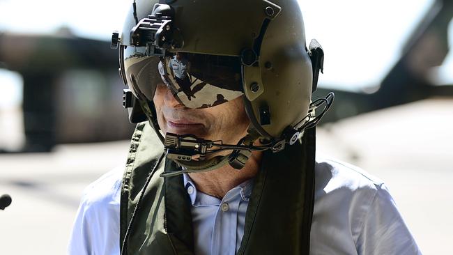 Prime Minister Tony Abbott arrives at RAAF Darwin aboard a blackhawk helicopter along with federal member for Solomon Natasha Griggs after undergoing a tour during military exercise Talisman Sabre in the Northern Territory.