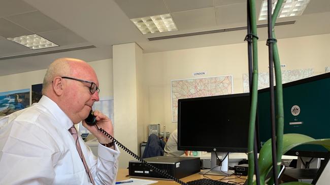 George Brandis manning the phones at Australia House in London, taking calls from frantic Aussies wanting to get home. Picture: Australia House