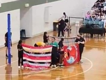 Officials hold up privacy screens while medical staff attend to Glasgow.