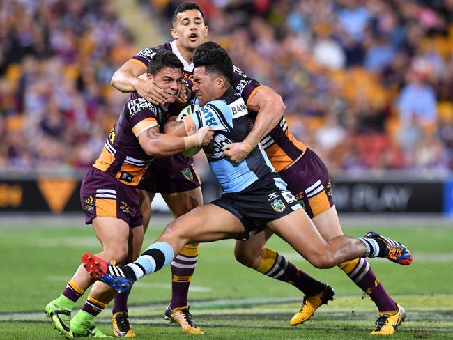 Sosaia Feki is crunched by Brisbane defenders.