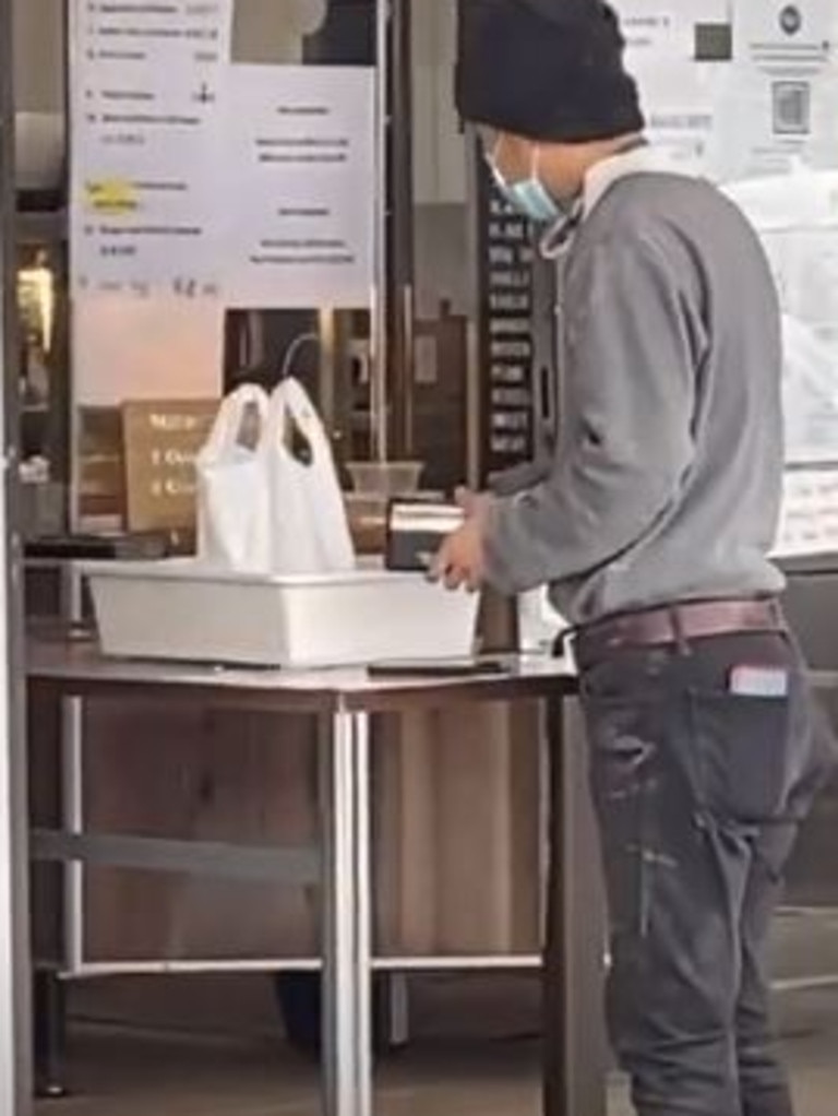 The meal is pushed to the customer in a white tray by a broom.