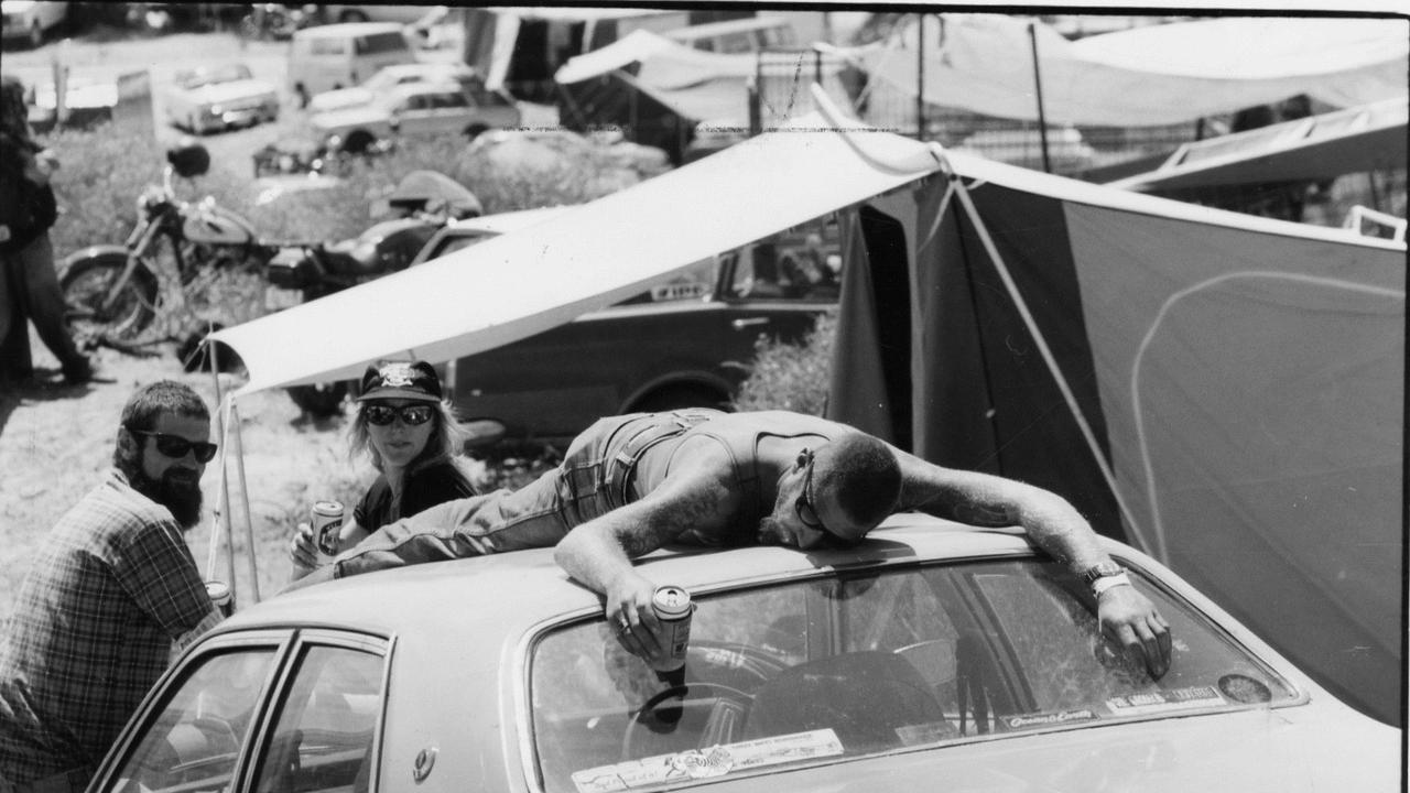 Music fans at Ponde rock music festival, held by the Hell’s Angels Motorcycle Club in Ponde near Mannum, SA, 21 Feb 1993. Michael ‘Rock’ Cudbertson, of Brighton, lying on the roof of motor car.