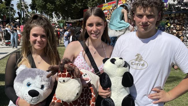 Yarra Valley mates Rub Serra with a husky dog, Marlee Smart with a giraffe, and Asher Inaps with a panda at Moomba.