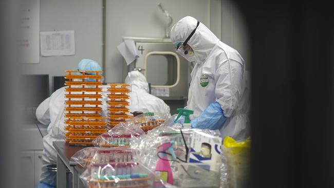 Medical workers in protective suits at a coronavirus detection lab in Wuhan. Picture: AP