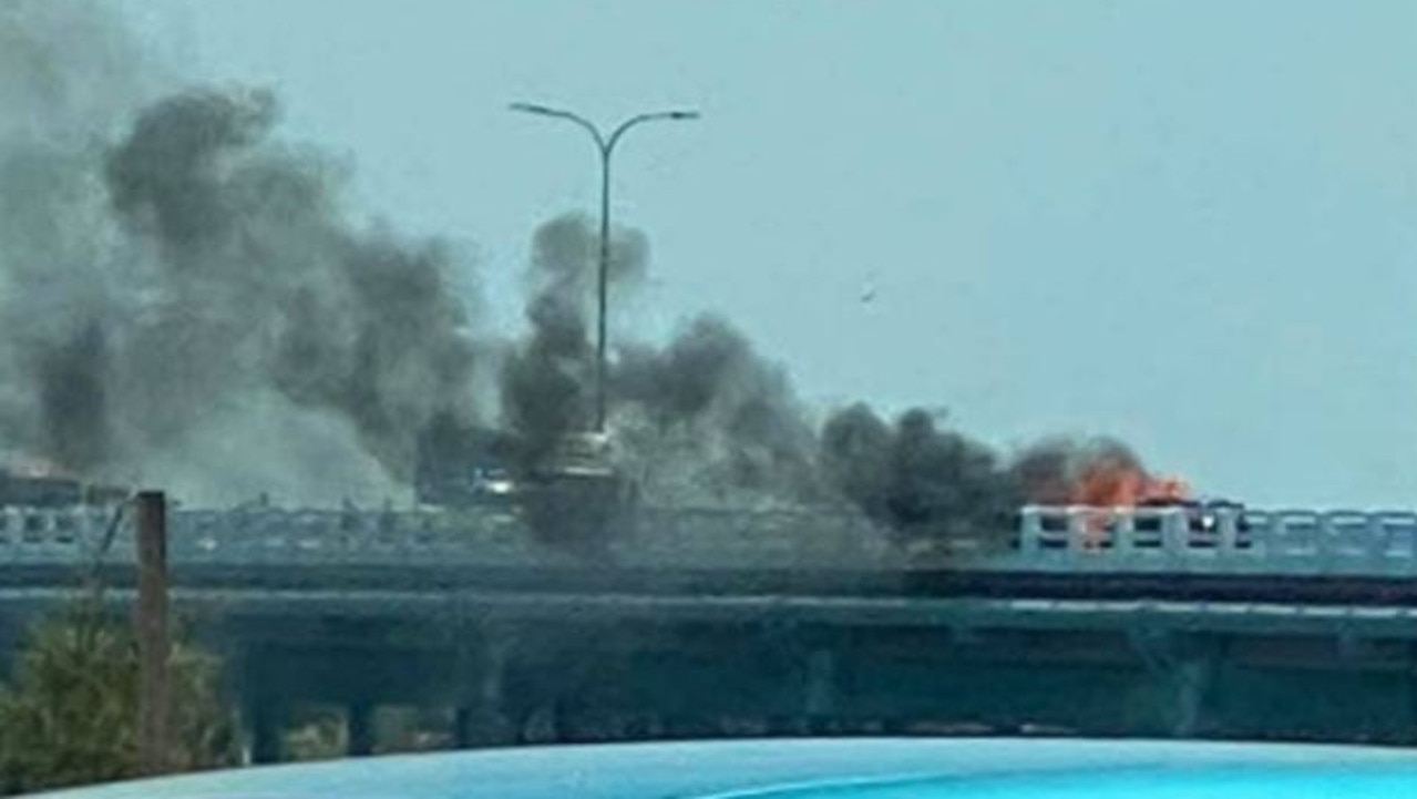 A two-car crash has closed Bribie Island Bridge. At least one car caught fire after impact. Picture: 7 News/Twitter