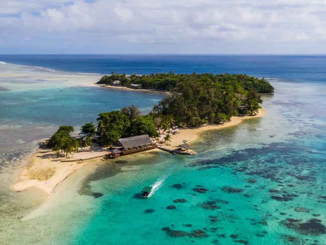 Aerial view of a boat carrying tourist to the stunning Erakor island in the Port Vila bay, just of Vanuatu capital city in the south Pacific on a sunny day.Escape Sat MagPhoto - Getty Images
