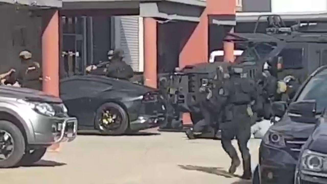 Heavily armed police storm the building.