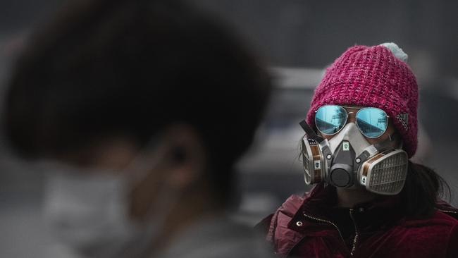 Many citizens of Beijing are wearing protective masks in an attempt to protect themselves against the coronavirus outbreak. Picture: Getty Images