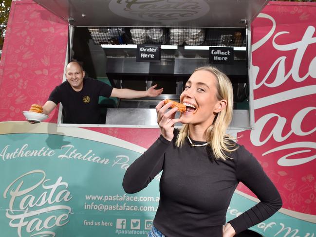 Taryn Reid with Italian savoury spaghetti doughnuts from Pasta Face at Queen Victoria Market. Picture: Nicki Connolly