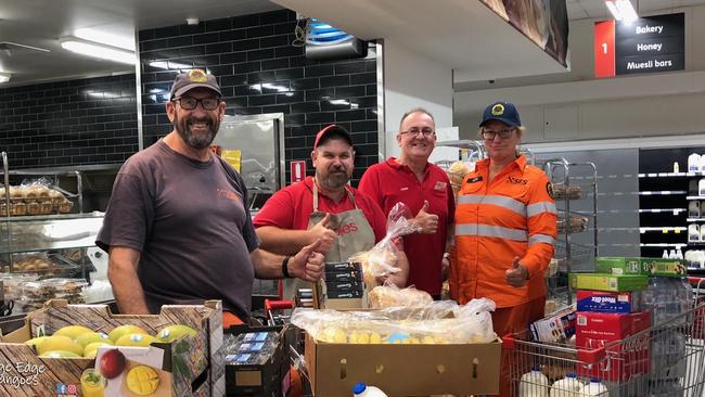 RFS Firefighters with Coles Batemans Bay team members receiving donations of full trolleys of groceries and fresh produce. Picture: supplied