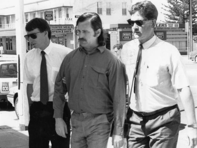Dieter Pfennig, being escorted by detectives into Murray Bridge police station in 1990, only came to trial for Louise Bell’s alleged murder 25 years later. Picture: News Corp