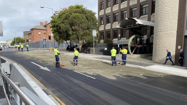 Hobart council workers attempting to control an oil spill in Hobart's CBD. Picture: Jessica Howard