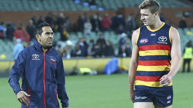 Eddie Betts, who finished the match in his tracksuit after injuring his hamstring, chats to Josh Jenkins who also saw little of the ball. Picture: Sarah Reed