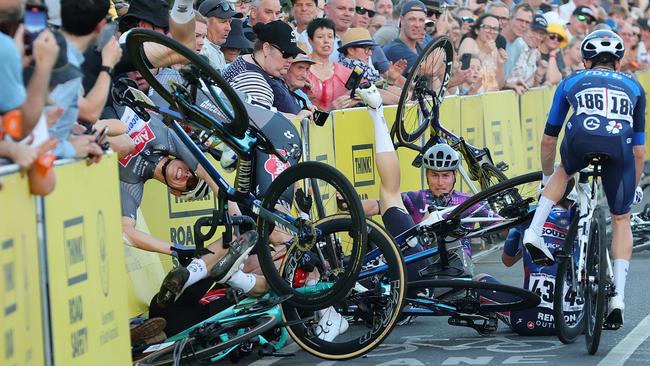 ADELAIDE, AUSTRALIA - JANUARY 18: Crash on last corner with two riders going over the barricade including Tobias BAYER of team DS: Meersman Gianni during day two of the Tour Down Under on January 18, 2025 in Adelaide, Australia. (Photo by Sarah Reed/Getty Images)