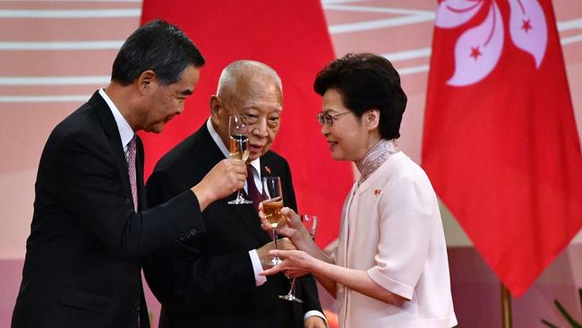 Hong Kong's chief executive Carrie Lam, right, makes a toast with former chief executives Tung Chee-hwa, centre, and Leung Chun-ying following a flag-raising ceremony to mark China's National Day celebrations in Hong Kong on July 1. Picture: AFP