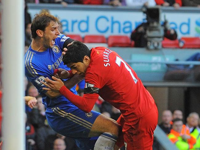 Luis Suarez (R) clashes with Chelsea defender Branislav Ivanovic after appearing to bite the Chelsea player. His second such offence.