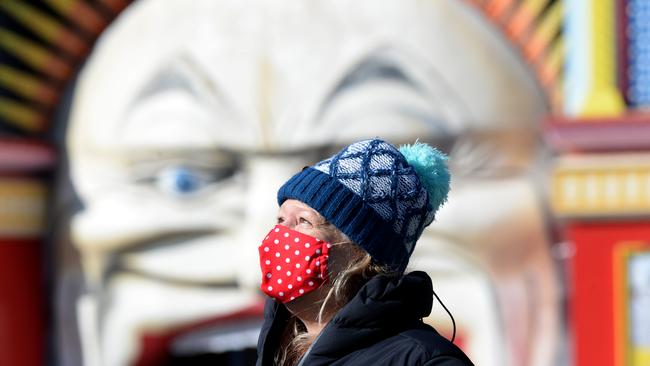 A masked Melburnian out walking in St Kilda. Picture: Andrew Henshaw