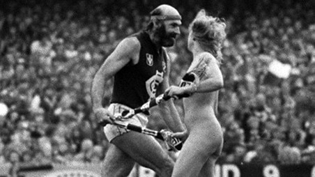 VFL Grand Final streaker Helen D'Amico tackles Carlton's Bruce Doull at the MCG in 1982. Picture: Clive Hyde