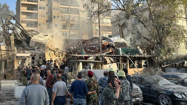 Emergency and security personnel gather at the site of strikes which hit a building adjacent to the Iranian embassy in Syria's capital Damascus, on April 1. Picture: AFP