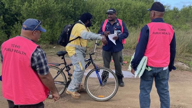 Torres and Cape Hospital and Health Service Environmental Health Workers Ezra Kris from St Paul’s community on Moa Island and Jacob Akiba from Saibai Island join Senior Cluster Acting Supervisor Dawson Mau from Dauan Island to talk to a passing Saibai Island resident. Photo: Supplied