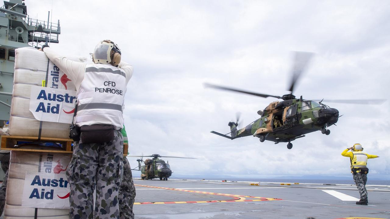 HMAS Adelaide drops disaster relief supplies to Nabouwalu on the island of Vanua Levu, Fiji, during Operation Fiji Assist in December 2020 after Category 5 cyclone Yasa.