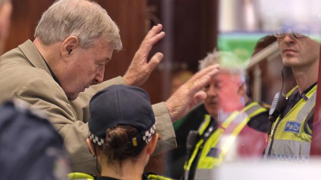 Cardinal George Pell was mobbed on his arrival at Melbourne Magistrates’ Court. Picture: AAP Image/Luis Ascui