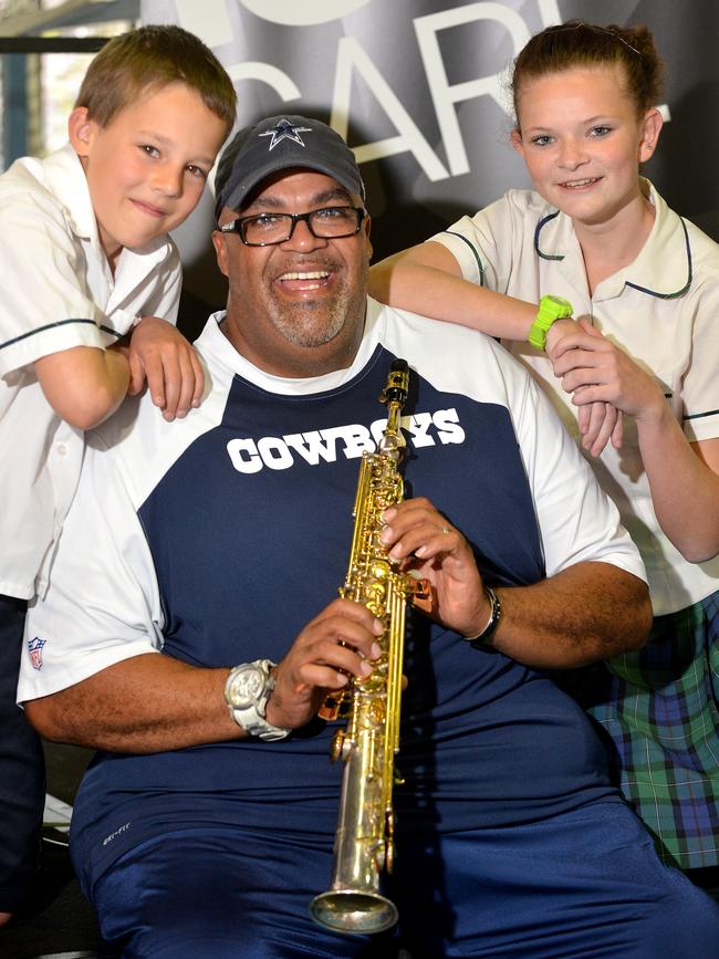 Reggie Dabbs and his saxophone visited Burnside State High School on the Sunshine Coast in 2014. Pictured with students Corben McCosker and Kiara Shepperd. Photo: Warren Lynam.