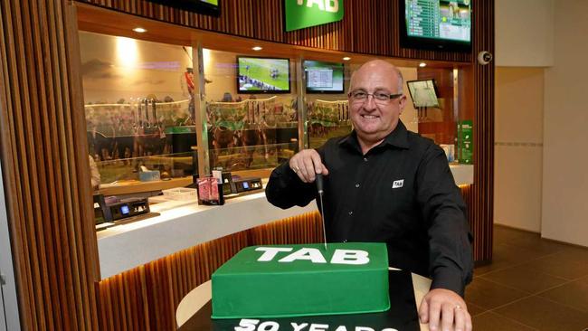 Glenn Munsie cuts the cake for the TAB's 50th. Picture: Stephen Cooper